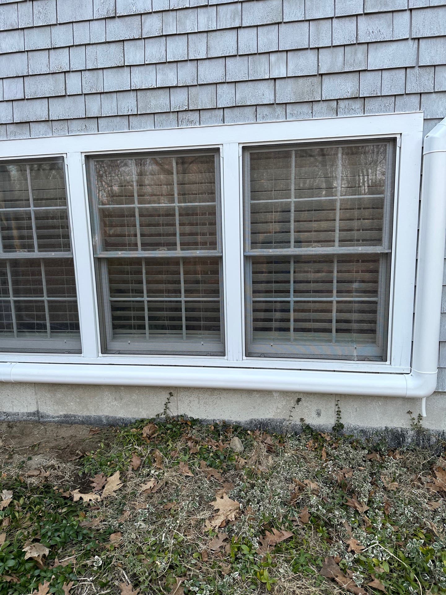 Line-set cover routed along the siding above basement windows