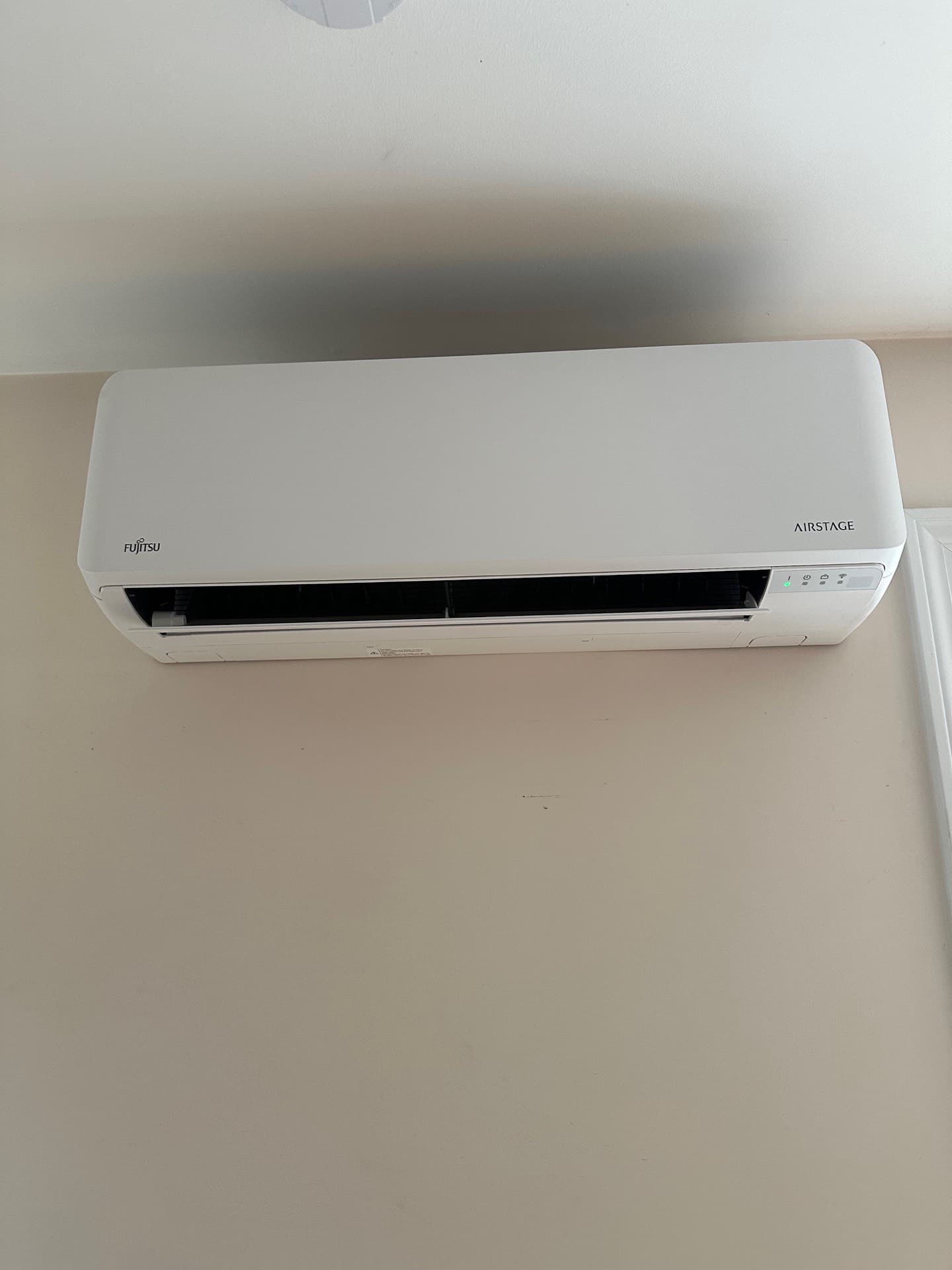 Fujitsu wall-mounted mini-split head installed in a finished living space