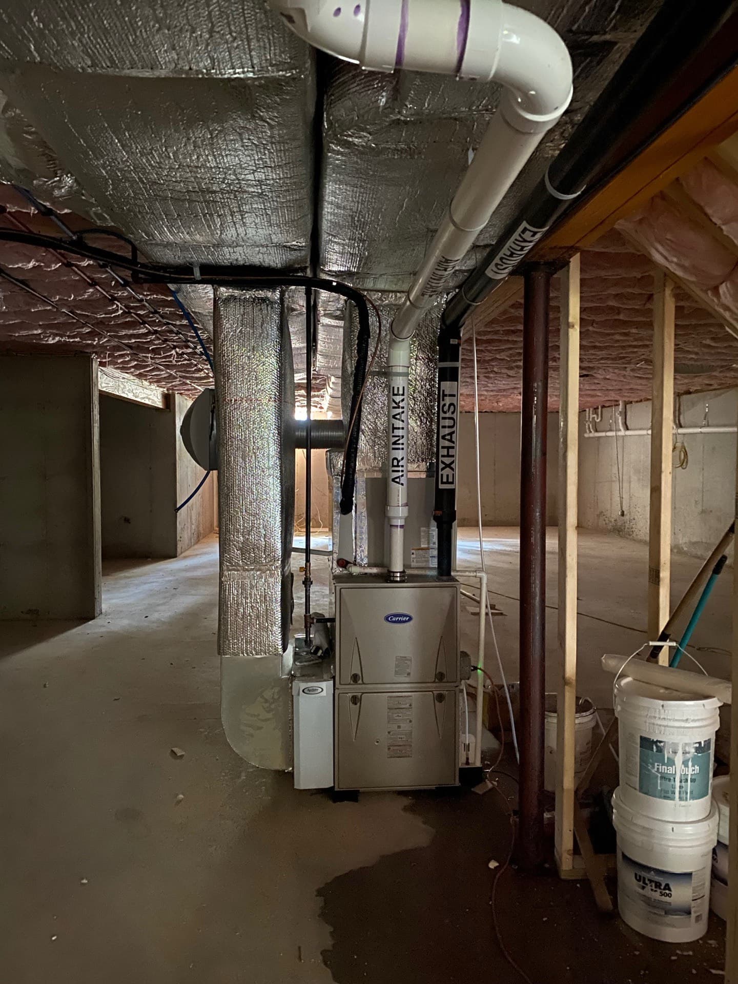 Carrier furnace and sheet-metal trunk ductwork in a basement mechanical room