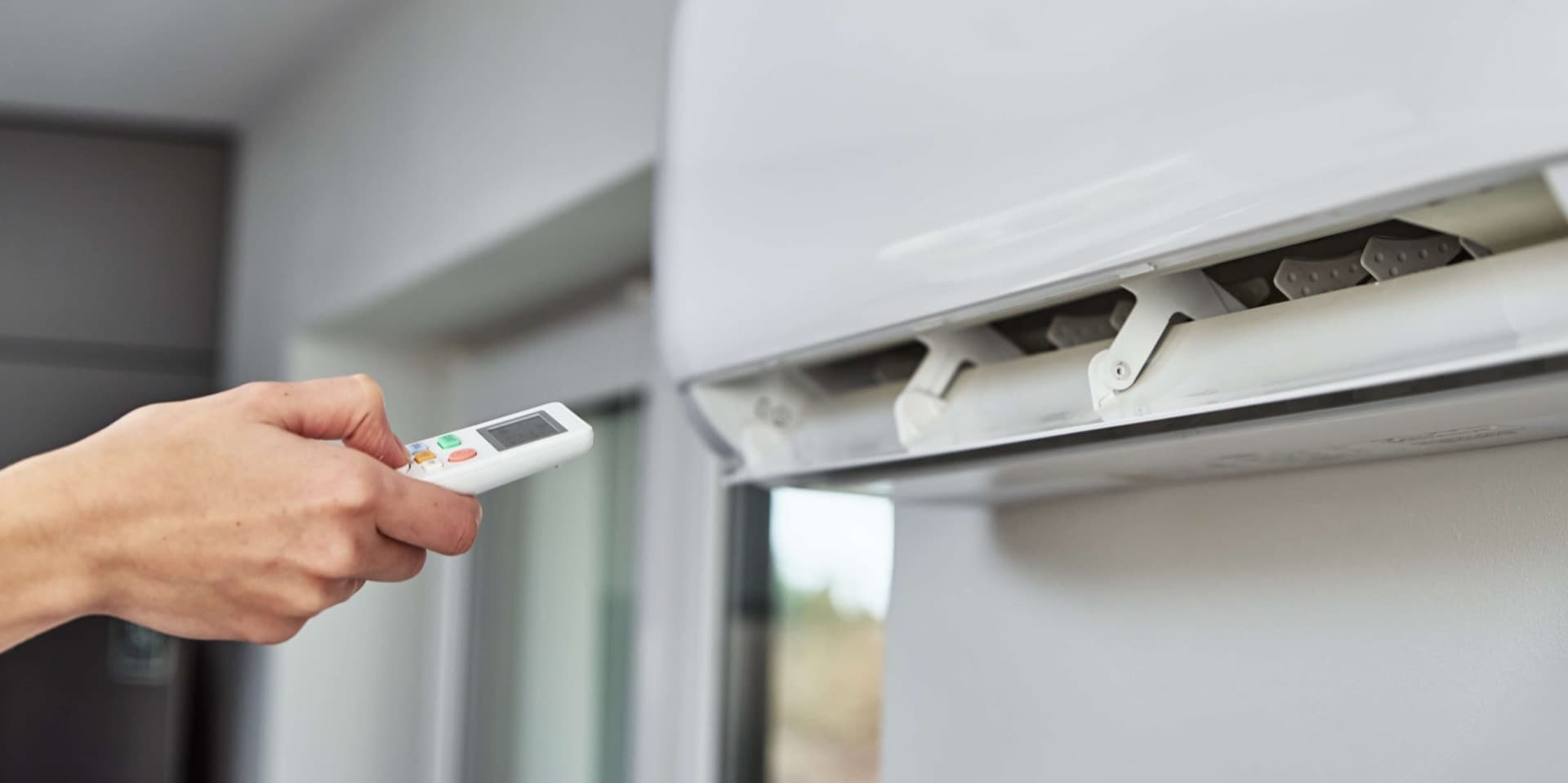 Technician performing maintenance on an energy-efficient mini-split